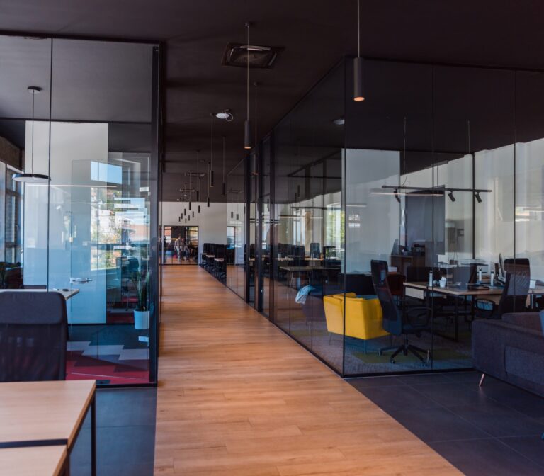 Modern glass-walled business startup office with open floor plan, relevant to warehouse build-out solutions southeast.